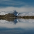 Der Piz Julier spiegelt sich mit einem imposanten Wolkenbild im Lej Muragl.